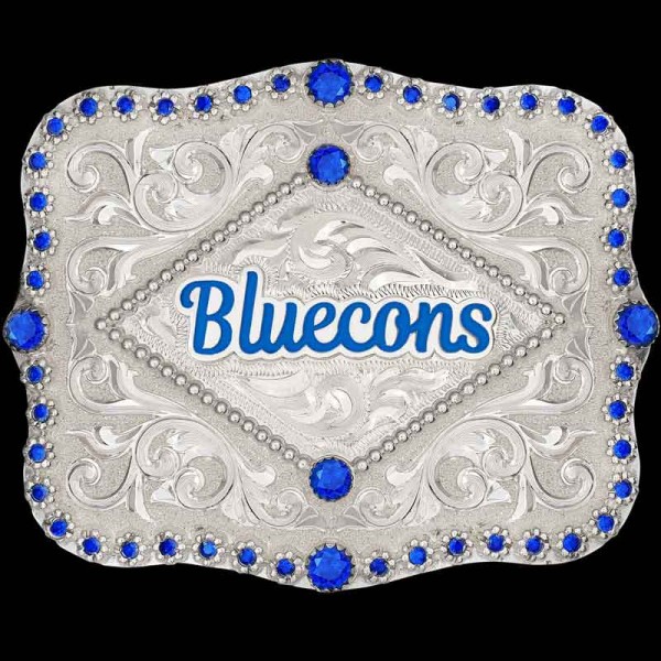 "Our Blue Springs belt buckle is a true showstopper for any cowboy or cowgirl. Expertly hand-engraved on a German Silver base, this buckle is sure to catch anyone's eye. It features intricate diamond-shaped bead detailing at the center, customizable 